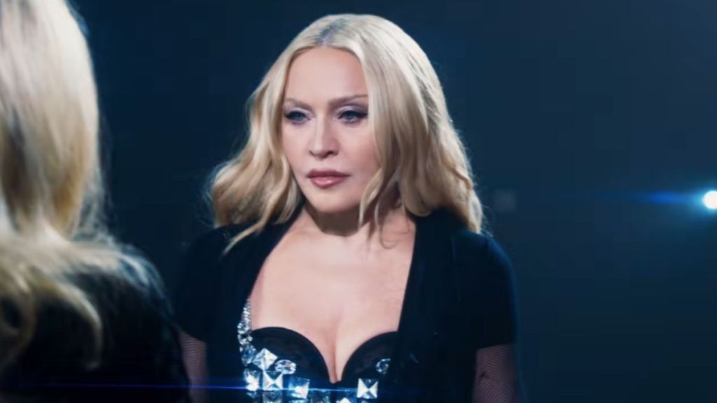 Madonna Twists & Turns on Table in Plunging Bodysuit