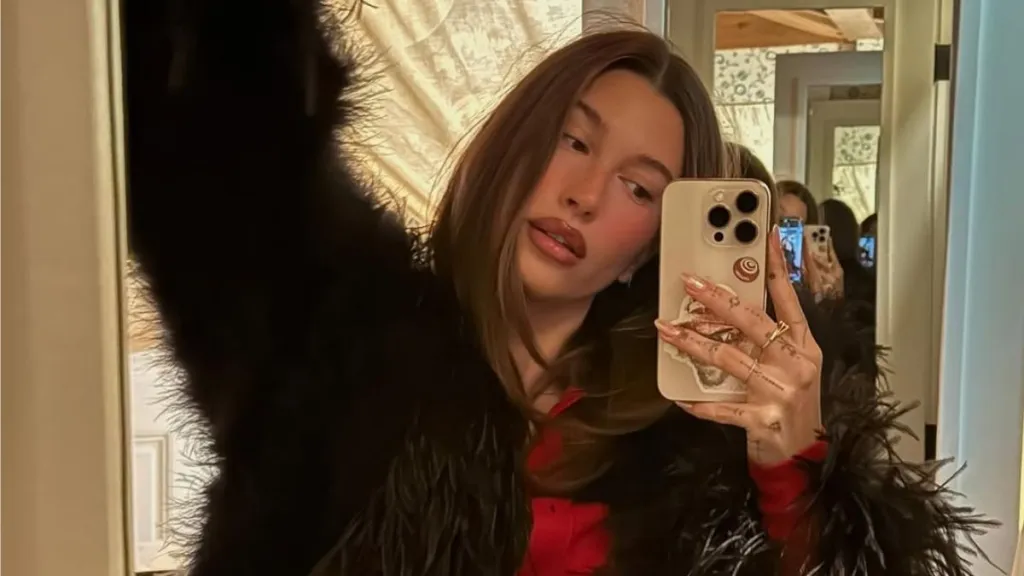 Hailey Bieber’s Loosely-Tied Robe Plunges Down To Expose Flirty Bra