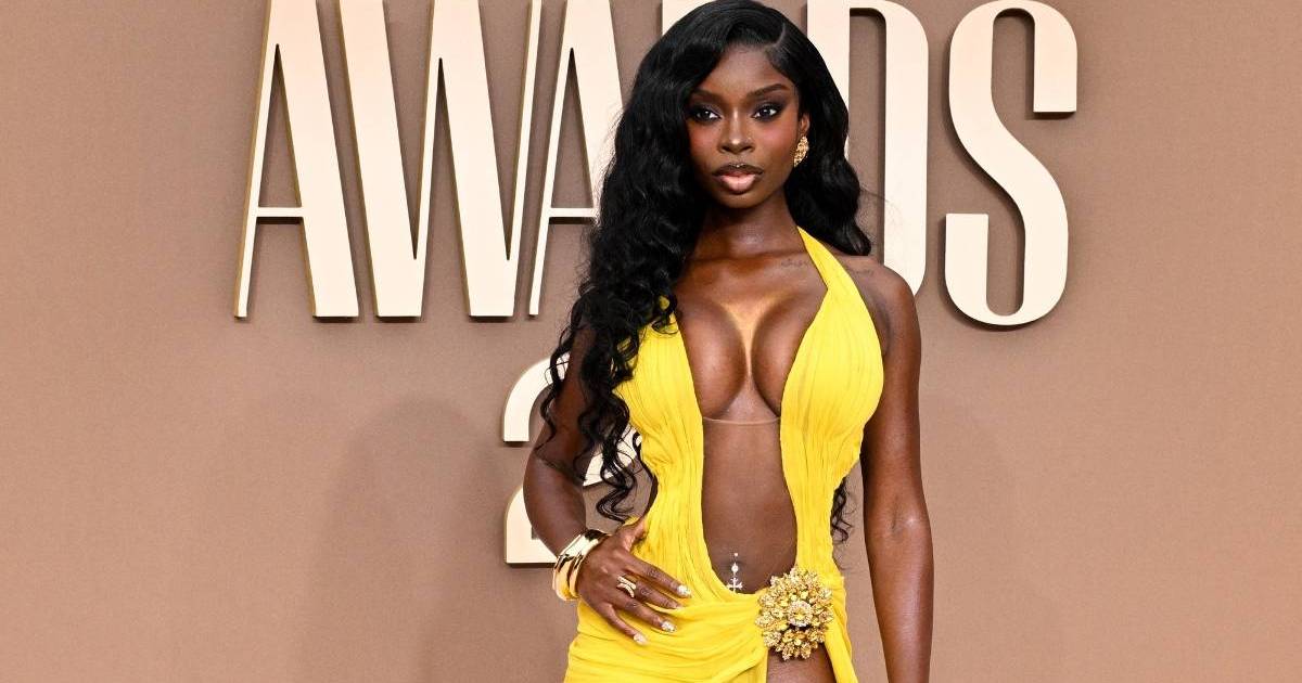 Olandria Carthen Wears Sheer Theo Philio Dress With Plunging Neckline at BET Awards