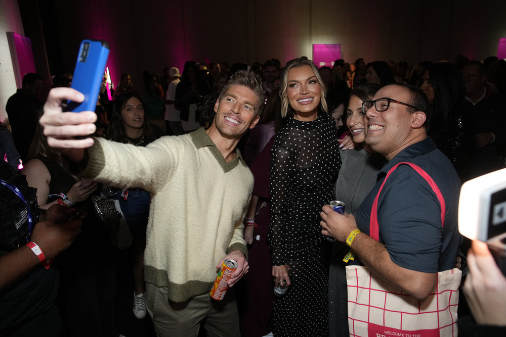 Kyle Cooke and LIndsay Hubbard posing with fans at BravoCon