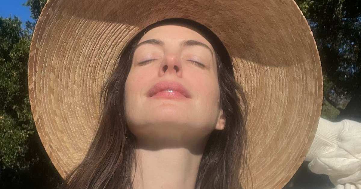 Anne Hathaway Almost Pops Out of Plunging Saint Laurent Striped Suit