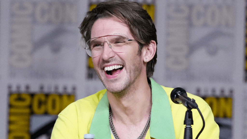 Dan Stevens speaking at a microphone during a public appearance