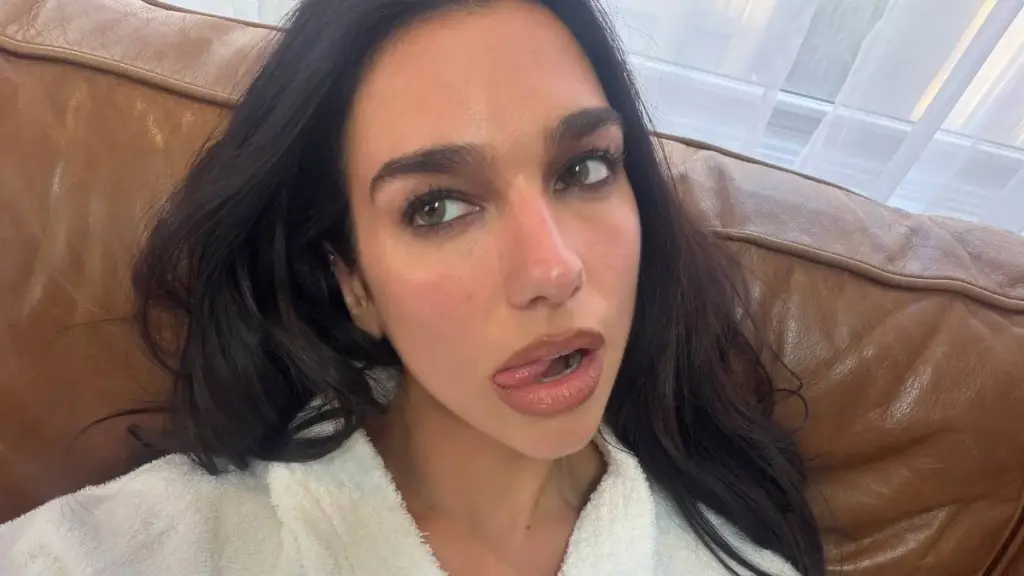 Dua Lipa’s Robe Is Seconds Away From Slipping as She Holds Tight