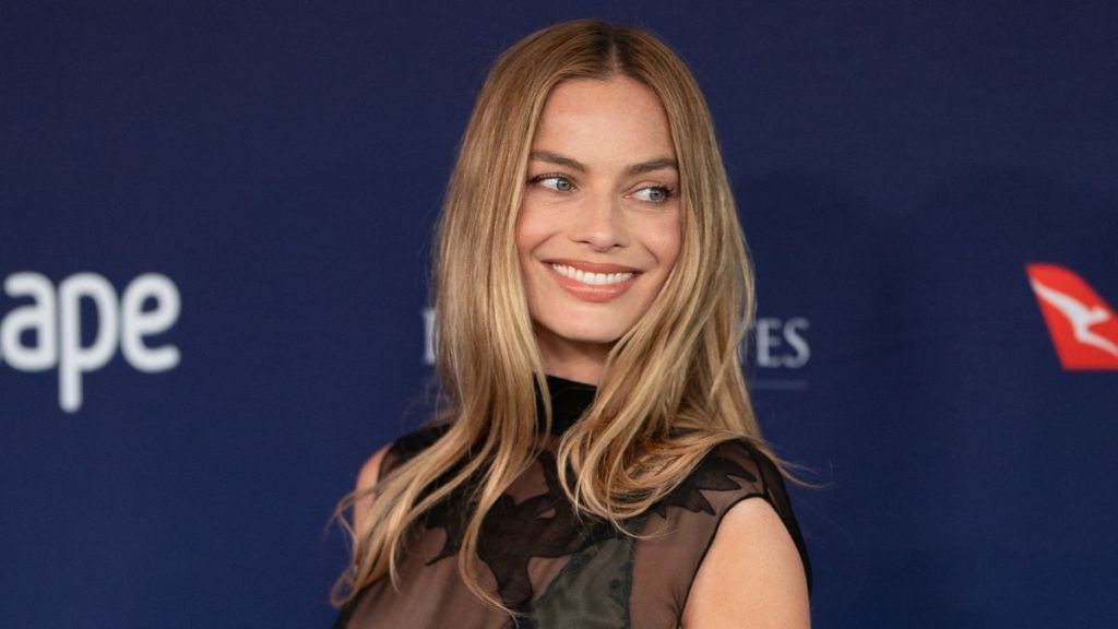 Margot Robbie's Frankies Bikinis Top Barely Hangs on Over Micro Shorts