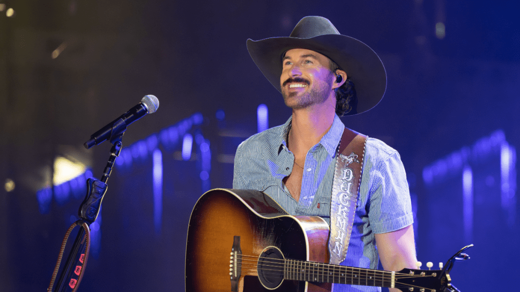Riley Green uses a drumstick to pick up underwear thrown onstage during his Maine concert